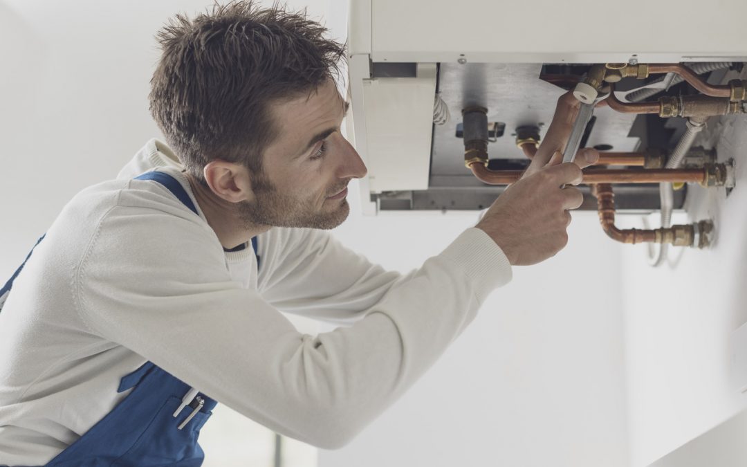 Professional heating engineer working on a boiler system
